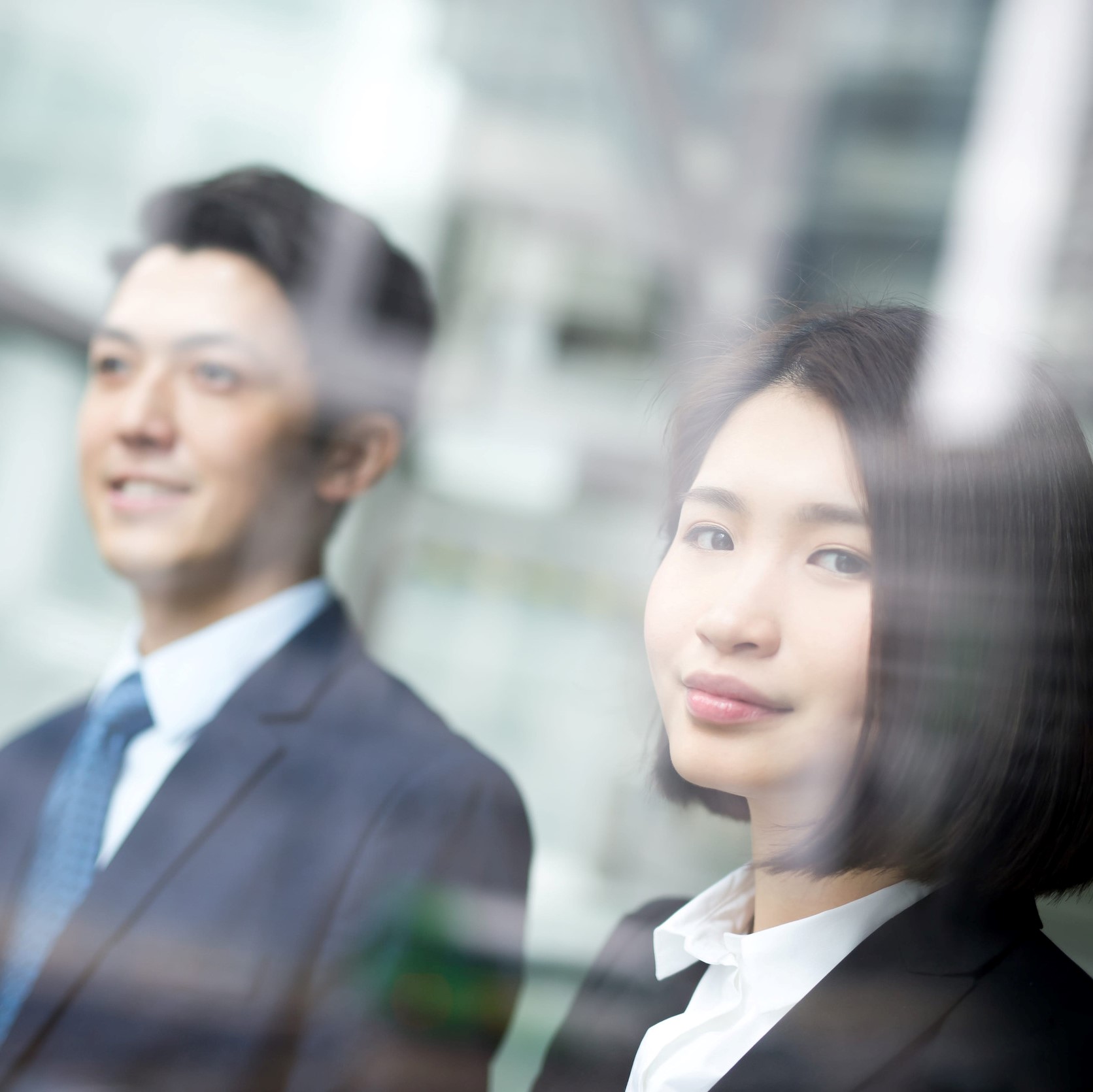 Business people team meeting in front of the office window, asian and caucasian
